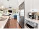 Open concept kitchen features stainless steel appliances, white cabinetry and is open to the living area at 511 Erie Ave, Tampa, FL 33606