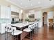 Open kitchen with large island, white cabinetry, stainless steel appliances, and modern bar stools at 511 Erie Ave, Tampa, FL 33606