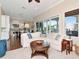 Open-concept living room with hardwood floors, large windows, kitchen view, and comfortable seating at 511 Erie Ave, Tampa, FL 33606