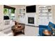 Comfortable living room with a fireplace, TV, built-ins, and cozy seating arrangement at 511 Erie Ave, Tampa, FL 33606