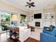 Cozy living room with a fireplace, built-in shelving, and sliding glass doors to outdoor space at 511 Erie Ave, Tampa, FL 33606