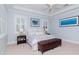 Serene main bedroom featuring light blue walls, shuttered windows, and a cozy sitting area at 511 Erie Ave, Tampa, FL 33606