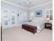 Tranquil main bedroom with light blue walls, shuttered windows, and access to a private balcony at 511 Erie Ave, Tampa, FL 33606