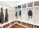 Well-organized mudroom with built-in storage, hooks, baskets, and wood flooring at 511 Erie Ave, Tampa, FL 33606