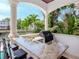 Elegant covered patio featuring an outdoor kitchen with a built-in grill and bar seating with waterfront views at 511 Erie Ave, Tampa, FL 33606