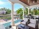 Covered patio with comfortable seating, outdoor grill, and stunning waterfront views for elegant entertaining at 511 Erie Ave, Tampa, FL 33606