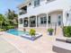 Beautiful outdoor living space featuring a pool, spa, covered patio, and well-manicured landscaping at 511 Erie Ave, Tampa, FL 33606