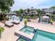 Inviting waterfront backyard with a pool, spa, and boat dock, creating an ideal setting for relaxation at 511 Erie Ave, Tampa, FL 33606