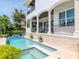Luxury home featuring a stunning pool and spa area with a covered patio, ideal for relaxation at 511 Erie Ave, Tampa, FL 33606