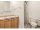 Bathroom featuring a shower, single sink vanity with a wooden cabinet, and tiled floors at 615 14Th Ne Ave, St Petersburg, FL 33701