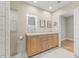 Bathroom featuring double sinks with wood cabinets, framed mirrors, and tile floors at 615 14Th Ne Ave, St Petersburg, FL 33701