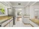 Bright kitchen features granite countertops, white cabinetry, and stainless steel refrigerator at 615 14Th Ne Ave, St Petersburg, FL 33701