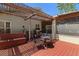 Back deck showcasing a pergola, grill, and seating area for outdoor enjoyment, bathed in sunlight at 7816 Citrus Blossom Dr, Land O Lakes, FL 34637