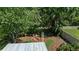 Aerial view of a serene backyard oasis with a bridge, sitting area, and lush, mature landscaping at 7816 Citrus Blossom Dr, Land O Lakes, FL 34637