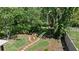 Overhead view of backyard featuring lush landscaping, a cozy seating area and charming bridge at 7816 Citrus Blossom Dr, Land O Lakes, FL 34637