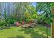 Landscaped backyard with a fire pit and seating, perfect for outdoor relaxation at 7816 Citrus Blossom Dr, Land O Lakes, FL 34637