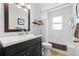 Bright bathroom features a dark vanity with a white countertop and tiled shower/bath at 7816 Citrus Blossom Dr, Land O Lakes, FL 34637