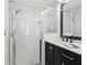 Bathroom with walk-in shower, black vanity and modern fixtures at 7816 Citrus Blossom Dr, Land O Lakes, FL 34637