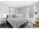 Relaxing guest bedroom featuring neutral decor, board and batten accent wall, and dark wood floors at 7816 Citrus Blossom Dr, Land O Lakes, FL 34637