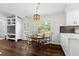 Bright dining room featuring hardwood floors, stylish lighting, and plantation shutters with views to the yard at 7816 Citrus Blossom Dr, Land O Lakes, FL 34637
