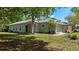Lovely single-Gathering home with a well-kept lawn, mature trees, and an attached two-car garage at 7816 Citrus Blossom Dr, Land O Lakes, FL 34637