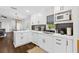Open concept kitchen with white cabinetry, gray subway tile backsplash, and stainless steel appliances at 7816 Citrus Blossom Dr, Land O Lakes, FL 34637
