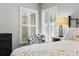 Comfortable main bedroom seating area, window shutters, and stylish neutral decor at 7816 Citrus Blossom Dr, Land O Lakes, FL 34637