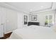 Bright main bedroom with white walls, tray ceiling, window shutters, and tasteful modern furnishings at 7816 Citrus Blossom Dr, Land O Lakes, FL 34637
