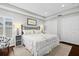 Main bedroom featuring plantation shutters, tray ceilings, and closet space at 7816 Citrus Blossom Dr, Land O Lakes, FL 34637