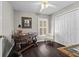 Well-lit office space with shuttered window, stylish desk, and dark wood floors at 7816 Citrus Blossom Dr, Land O Lakes, FL 34637