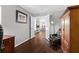 Home office space featuring hardwood floors and furniture, with a view into the home's living spaces at 7816 Citrus Blossom Dr, Land O Lakes, FL 34637