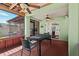 Screened-in patio with a ceiling fan and wood flooring, perfect for outdoor dining and relaxation at 7816 Citrus Blossom Dr, Land O Lakes, FL 34637