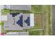 Aerial view of home featuring solar panels, fenced yard, and proximity to a pond at 8749 Parsons Hill Blvd, Wesley Chapel, FL 33545