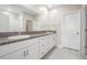 Bathroom with double sink vanity, granite counters, white cabinetry, and a separate shower at 8749 Parsons Hill Blvd, Wesley Chapel, FL 33545