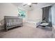 A spacious bedroom with a ceiling fan, carpeted floors, and a Happy Birthday banner at 8749 Parsons Hill Blvd, Wesley Chapel, FL 33545
