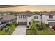 Charming two-story home featuring a well-manicured lawn and attached two-car garage at 8749 Parsons Hill Blvd, Wesley Chapel, FL 33545