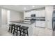 Kitchen featuring granite countertops, white cabinetry, stainless steel appliances, and a center island with seating at 8749 Parsons Hill Blvd, Wesley Chapel, FL 33545