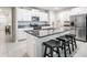 Bright kitchen with white cabinets, granite countertops, stainless steel appliances, and a convenient center island with seating at 8749 Parsons Hill Blvd, Wesley Chapel, FL 33545