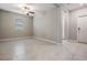 Spacious living area featuring tiled flooring, a ceiling fan, and a window with abundant natural light at 8749 Parsons Hill Blvd, Wesley Chapel, FL 33545