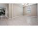 Spacious living area featuring tiled flooring, a ceiling fan, and a window with abundant natural light at 8749 Parsons Hill Blvd, Wesley Chapel, FL 33545