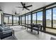 Sunroom featuring dark trim around many windows showing the view of the backyard at 8749 Parsons Hill Blvd, Wesley Chapel, FL 33545