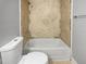 Bathroom showcasing tile-lined tub, shower, and toilet at 9481 Highland Oak Dr # 703, Tampa, FL 33647