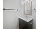 Bathroom featuring dark vanity, mirror, and towel rack at 9481 Highland Oak Dr # 703, Tampa, FL 33647
