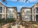 Exterior view of the townhome complex with blue sky and walkway at 9481 Highland Oak Dr # 703, Tampa, FL 33647