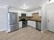 Modern kitchen features stainless steel appliances, white cabinetry, and stylish tile flooring at 9481 Highland Oak Dr # 703, Tampa, FL 33647