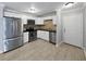 Modern kitchen features stainless steel appliances, white cabinetry, and stylish tile flooring at 9481 Highland Oak Dr # 703, Tampa, FL 33647