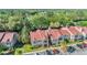 Aerial view of a two-story condo complex with a red roof, parking and lush landscaping at 9481 Highland Oak Drive # 602, Tampa, FL 33647
