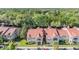Beautiful condo community featuring lush landscaping and a distinctive red tile roof, surrounded by natural Florida landscape at 9481 Highland Oak Drive # 602, Tampa, FL 33647