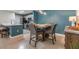 Open-concept kitchen and dining area with modern lighting, tile floors, and stainless steel appliances at 9481 Highland Oak Drive # 602, Tampa, FL 33647