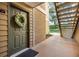 Stylish front door with a wreath and stairs leading up to the second floor at 9481 Highland Oak Drive # 602, Tampa, FL 33647